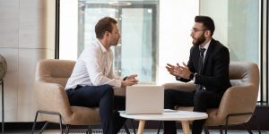 Middle,Eastern,And,Caucasian,Ethnicity,Businessmen,Seated,On,Armchair,In